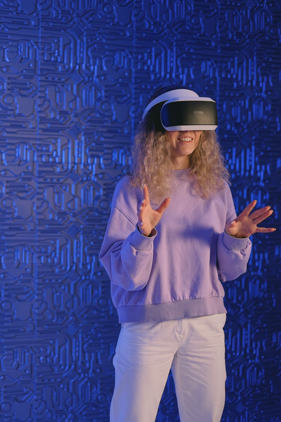 A learner in a VR headset against a blue circuit backdrop