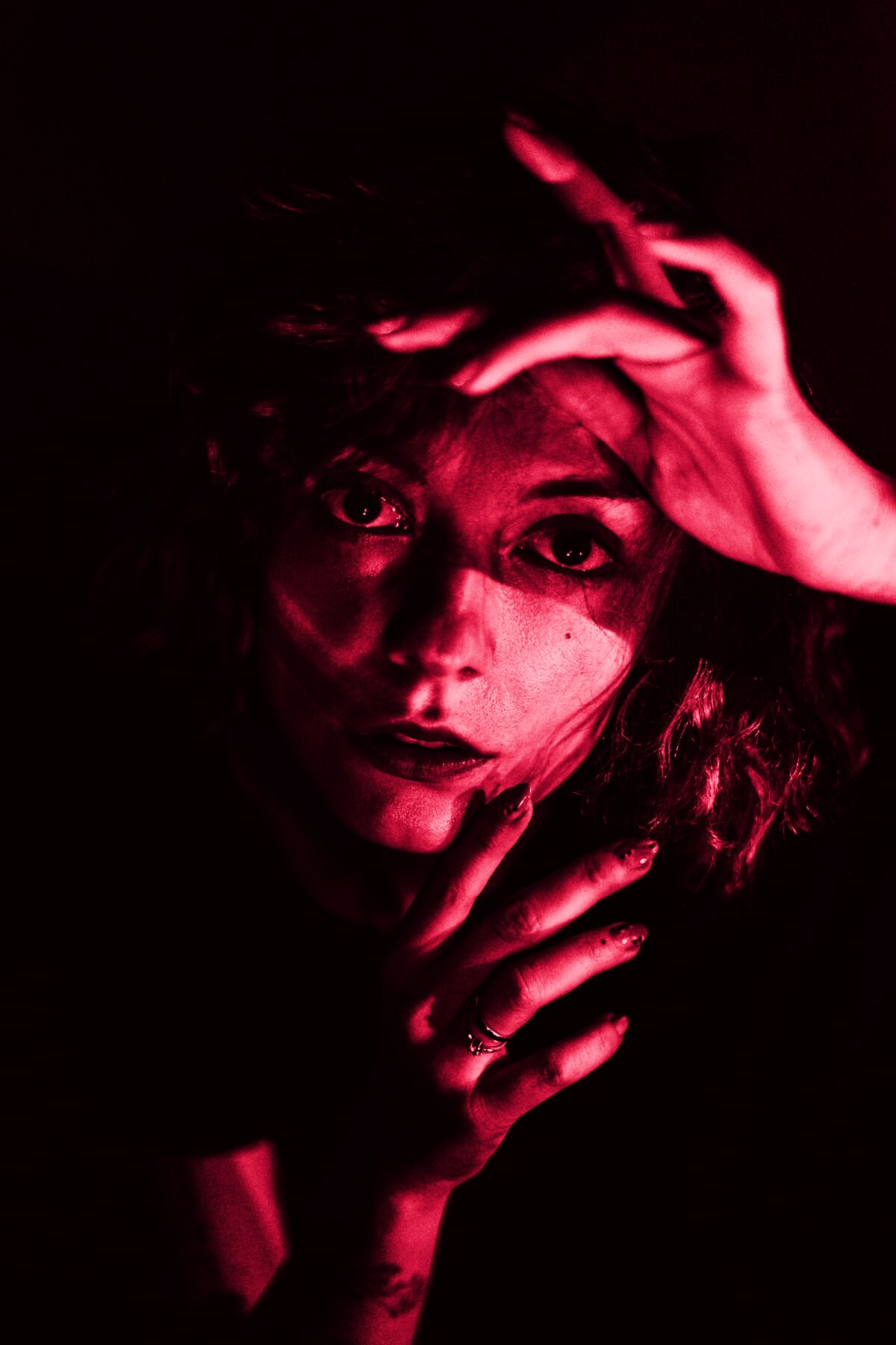 A woman framing her face with her hands