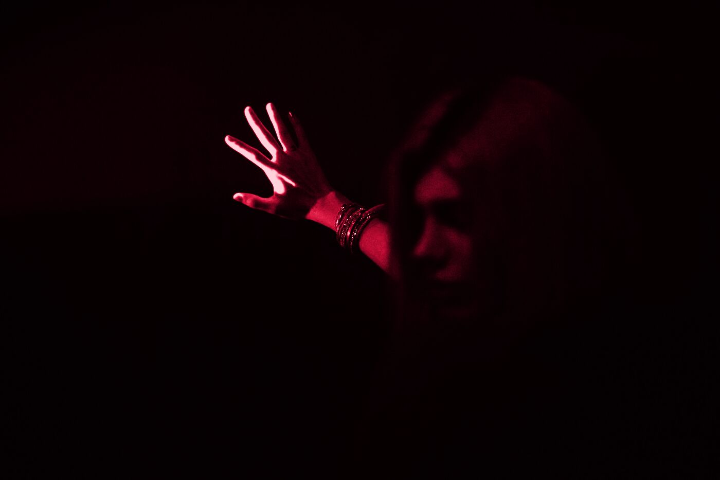 A hand reaching into red light