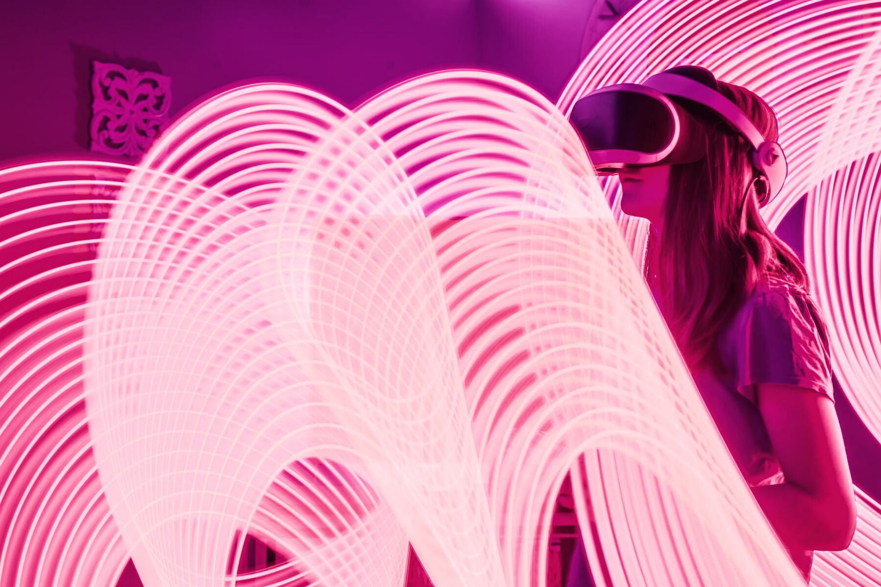 A woman in a VR headset inside rings of light